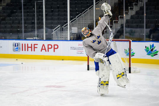 Goaltender Carl Lindbom of Sweden celebrates at a practice