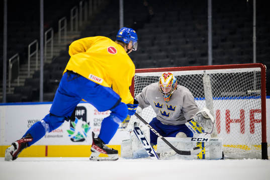 Albert Sjöberg and goaltender Carl Lindbom of Sweden at a