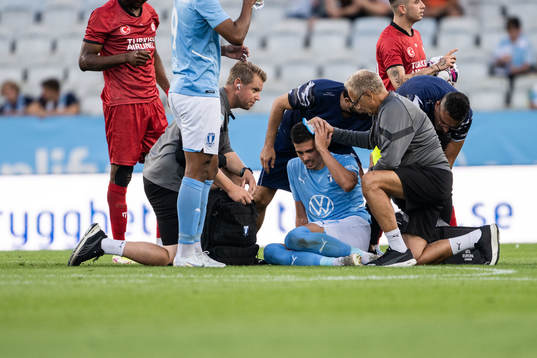 Dennis Hadzikadunic of Malmö FF receives medical treatment