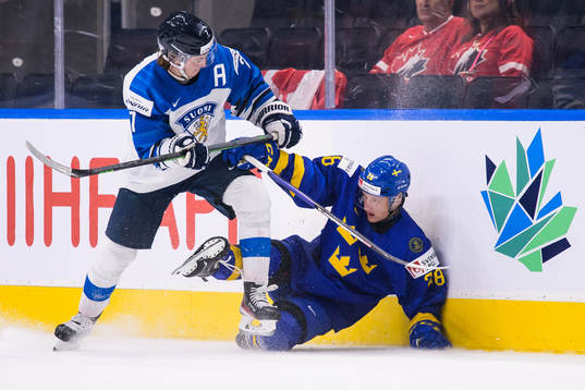 Topi Niemelä of Finland tackles Oskar Magnusson of Sweden