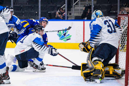 Leo Lööf of Sweden shoots the puck against goaltender