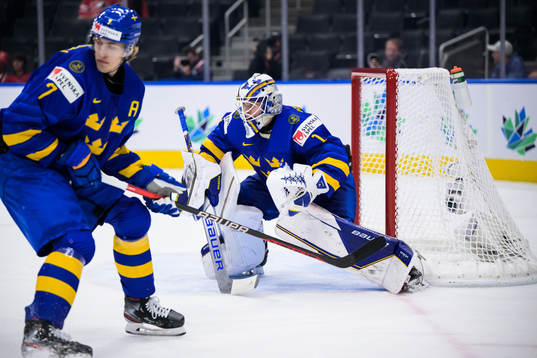Simon Edvinsson and goaltender Jesper Wallstedt of Sweden