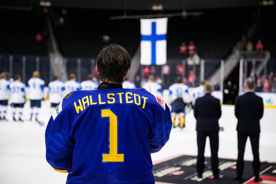 Goaltender Jesper Wallstedt of Sweden sees the Finnish flag