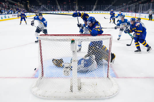 Daniel Torgersson of Sweden in front of goaltender Juha
