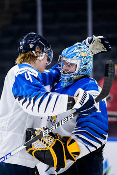Joni Jurmo and goaltender Juha Jatkola of Finland embrace