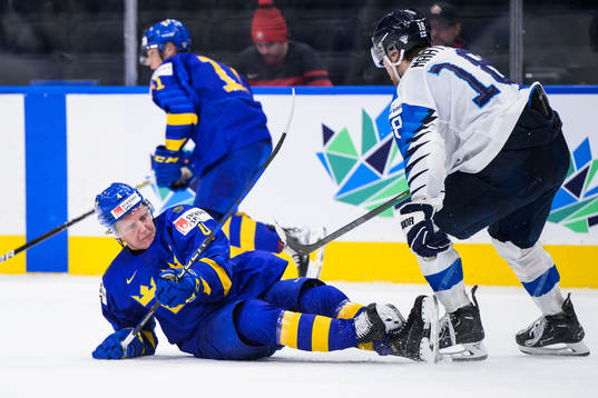 Emil Andrae of Sweden trips in front of Joel Määttä of