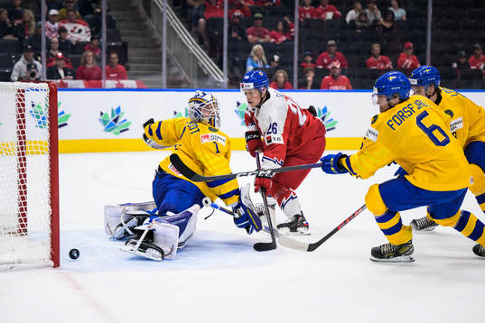 Goaltender Jesper Wallstedt of Sweden lets in the 1-1 goal