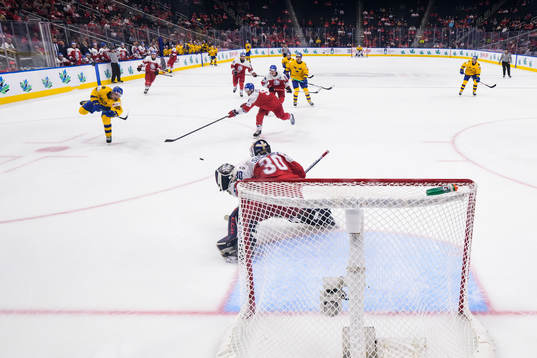 Linus Sjödin of Sweden scores 3-1 behind goaltender Tomas