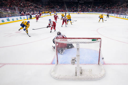 Linus Sjödin of Sweden scores 3-1 behind goaltender Tomas