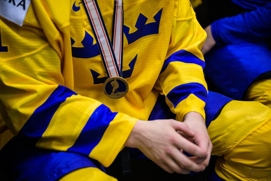 A bronze medal hangs around the neck of Oskar Olausson of