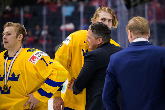 Head coach Tomas Montén hugs Simon Edvinsson of Sweden