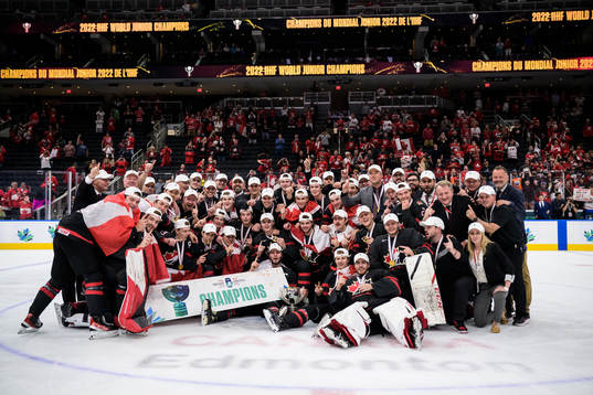 Players and coaching staff of Canada pose for a group photo