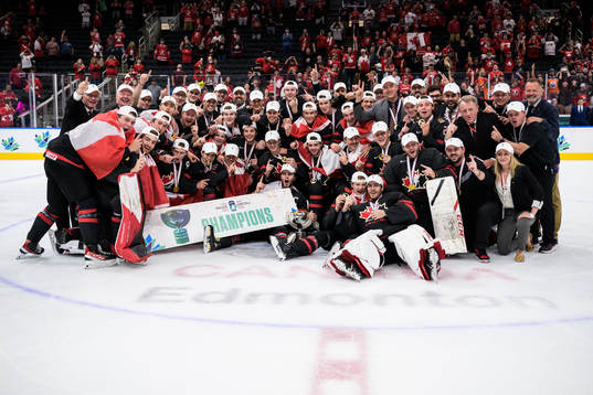Players and coaching staff of Canada pose for a group photo