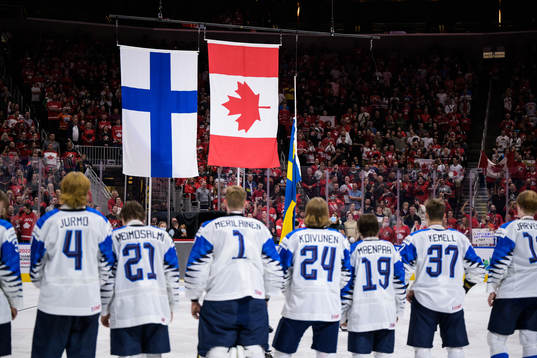 The flags of Finland, Canada and Sweden are hoisted in