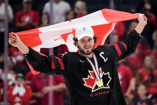 Mason McTavish of Canada celebrates with a Canadian flag