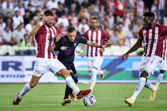 Dimitris Goutas and Aaron Appindangoye of Sivasspor against