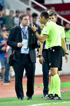 An official talks to the referee