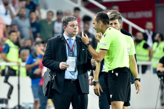 An official talks to the referee