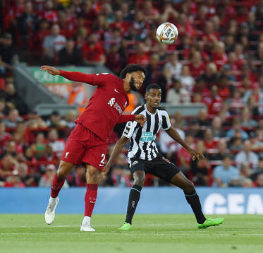 Joe Gomez of Liverpool and Alexander Isak of Newcastle