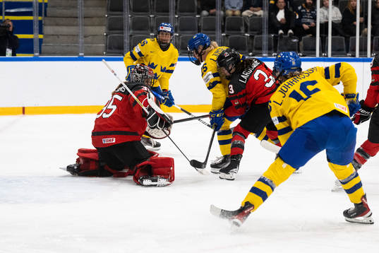 Lina Ljungblom of Sweden and goaltender Ann-Renee Desbiens