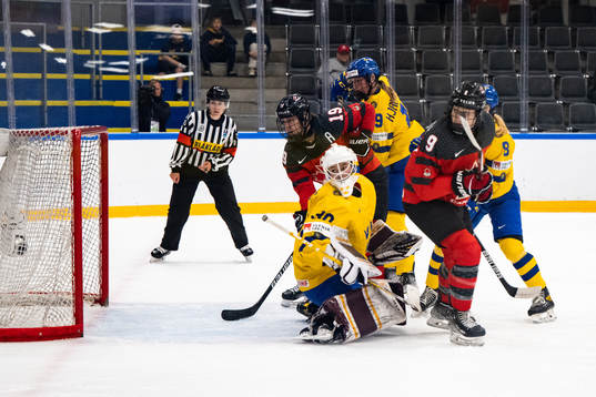 Goaltender Emma Söderberg of Sweden and Brianne Jenner and
