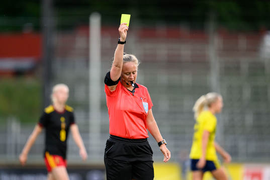 Referee Sandra Almkvist shows a yellow card
