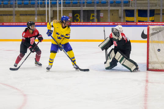 Akane Hosoyamada and goaltender Miyuu Masuhara of Japan