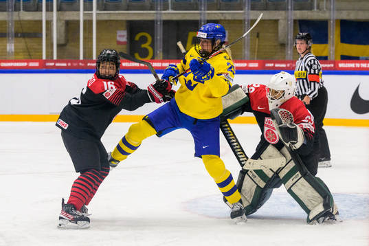Yoshino Enomoto and goaltender Miyuu Masuhara of Japan