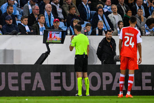Referee Duje Strukan reviews a penalty situation