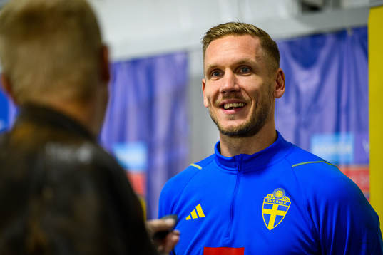Goalkeeper Robin Olsen is interviewed by the media