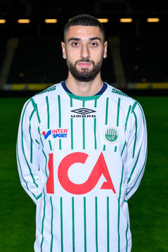 Aiham Ousou poses for a portrait with the jersey of his