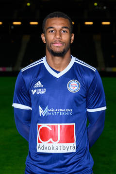 Isak Hien poses for a portrait with the jersey of his