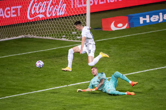 Benjamin Sesko of Slovenia and goalkeeper Robin Olsen of
