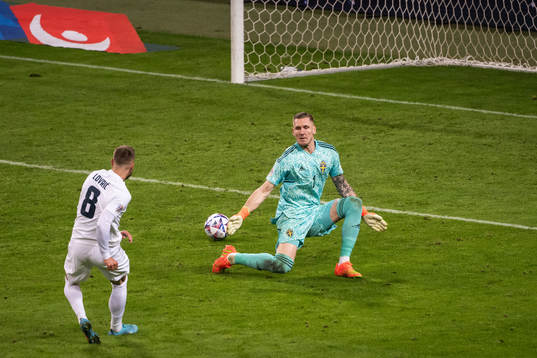 Sandi Lovric of Slovenia and goalkeeper Robin Olsen of