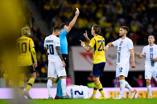Kristoffer Olsson of Sweden receives a yellow card