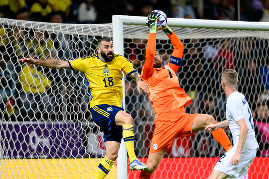 Mikael Ishak of Sweden and goalkeeper Jan Oblak of Slovenia