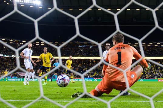 Goalkeeper Jan Oblak of Slovenia saves a ball from Robin