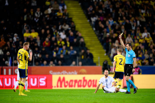 Dejan Kulusevski of Sweden receives a yellow card