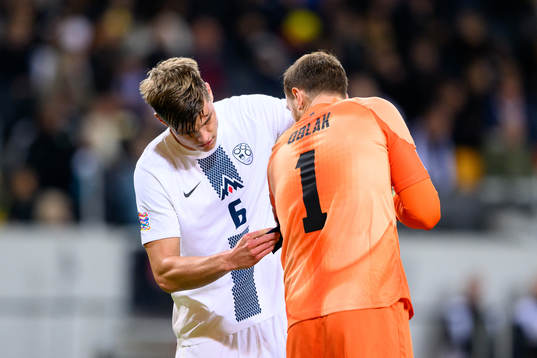 Jaka Bijol and goalkeeper Jan Oblak of Slovenia