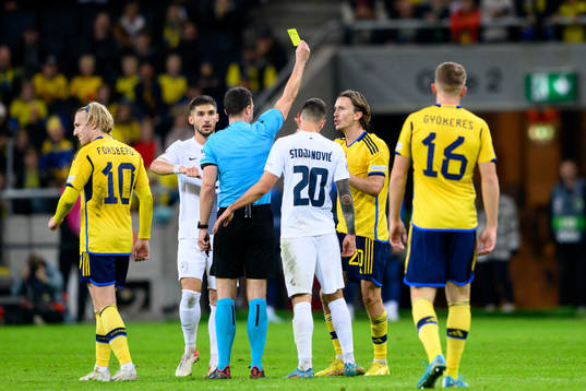 Kristoffer Olsson of Sweden receives a yellow card
