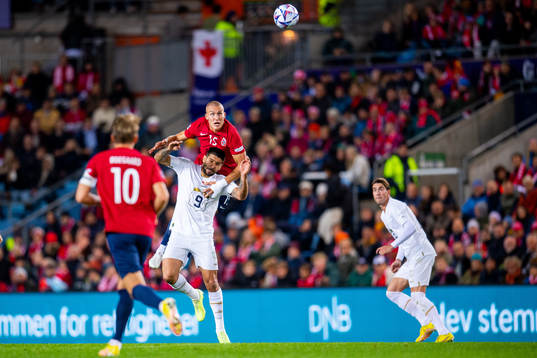 Aleksandar Mitrovic of Serbia and Leo Skiri Østigård of
