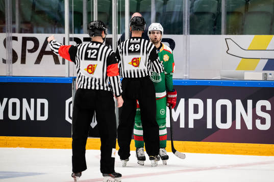 Daniel Zaar of Rögle and Referee Emils Druseiks