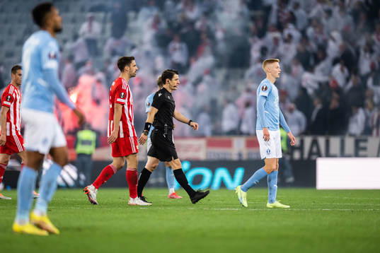 Referee Halil Umut Meler gathers the players