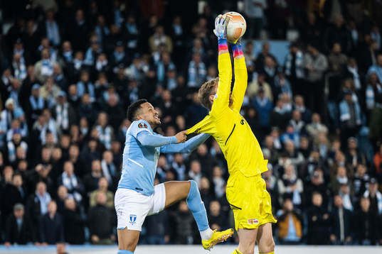 Martin Olsson of Malmö FF and goalkeeper Frederik Rönnow