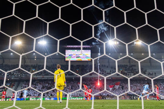 A flare is thrown onto the pitch