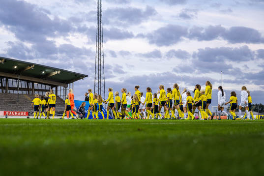 The teams enter the pitch