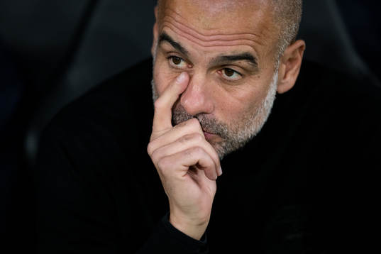 Head coach Pep Guardiola of Man City looks dejected
