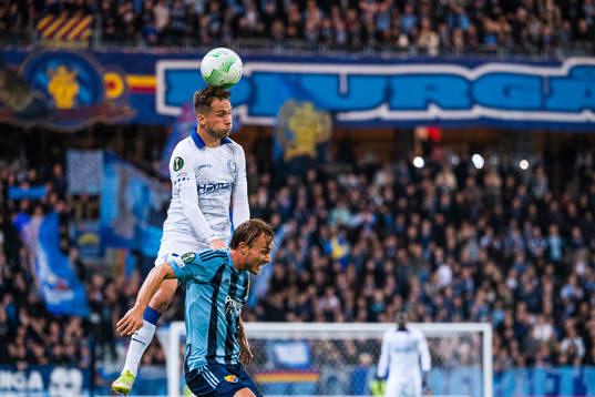 Andrew Hjulsager of Gent heads the ball over Pierre