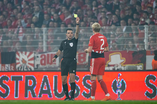 Morten Thorsby of Union Berlin receives a yellow card for