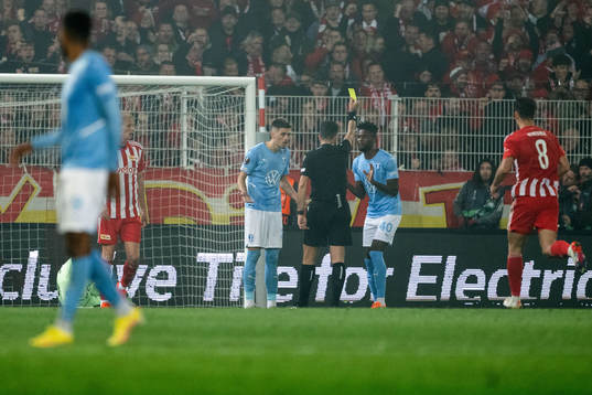 Emmanuel Lomotey of Malmö FF receives a yellow card from